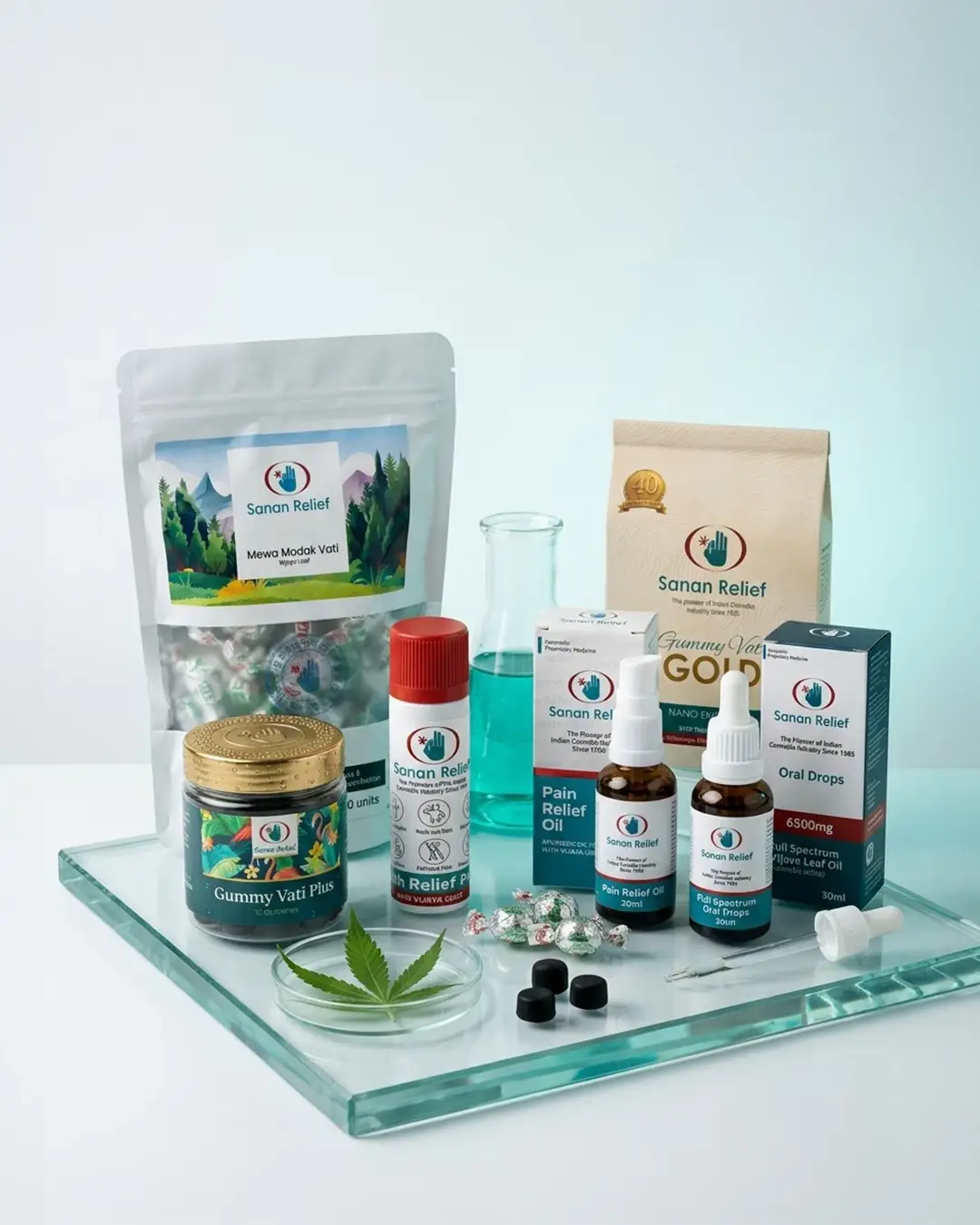Sanan Relief range – Pain Relief Oil, Oral Drops, Gummy Vati Plus, Gummy Vati Gold and Mewa Modak Vati on a glass lab bench